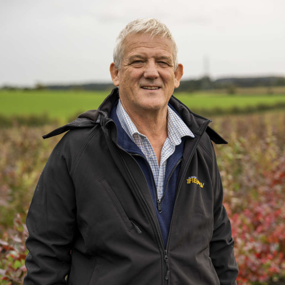 Photo showing Adrian Howell standing in a field